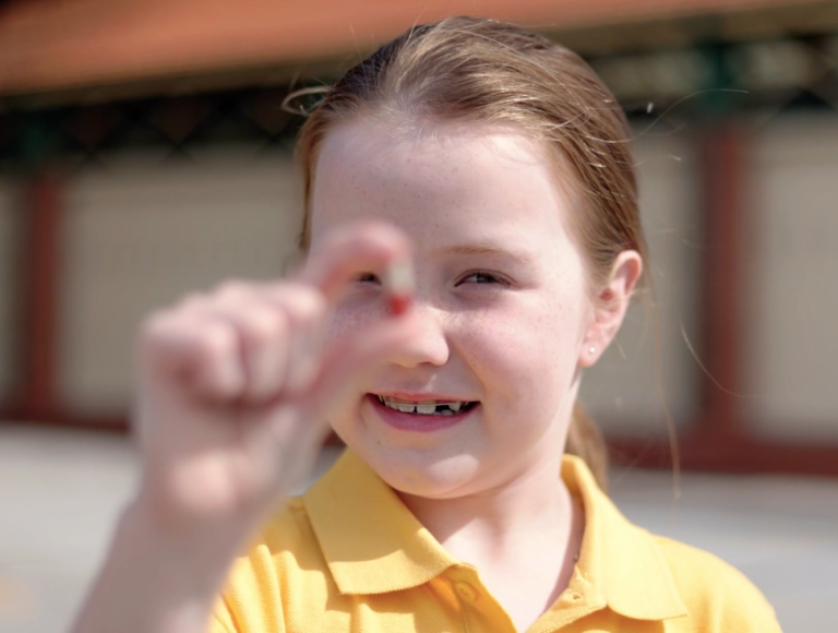 Student holding treatment medication